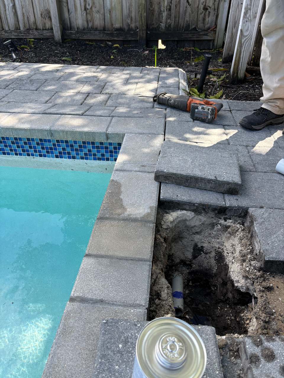 repair-leak - Downtown Pools Pool deck pavers lifted to trace a plumbing leak before opening concrete